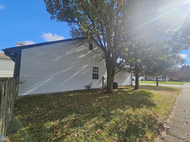 view of side of home with a yard