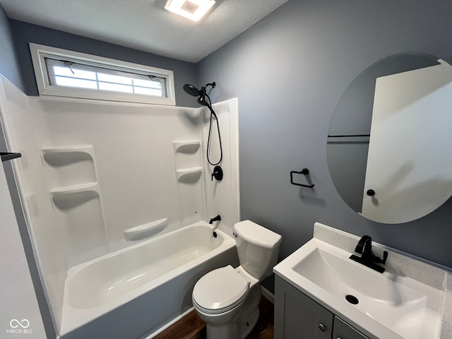 full bathroom featuring hardwood / wood-style flooring, vanity, bathtub / shower combination, and toilet