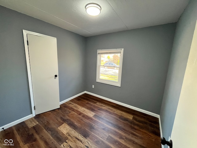 empty room featuring dark hardwood / wood-style flooring