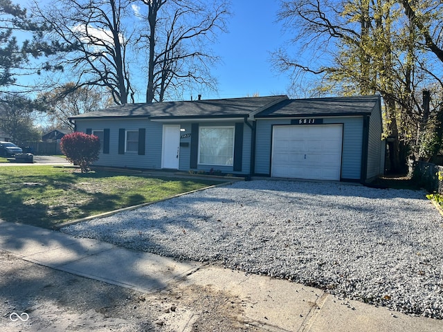 single story home featuring a front lawn and a garage