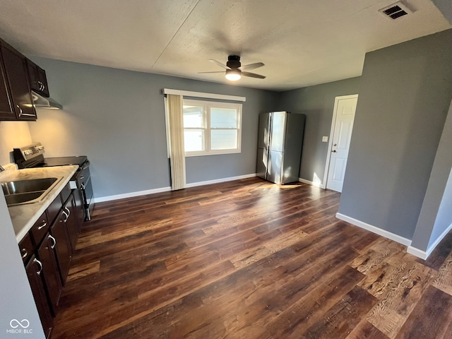 kitchen featuring dark hardwood / wood-style flooring, electric range, stainless steel refrigerator, and dark brown cabinets