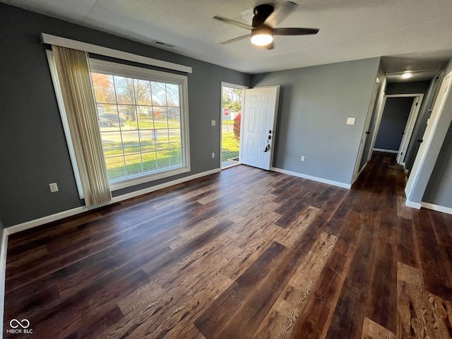 spare room with ceiling fan and dark hardwood / wood-style flooring