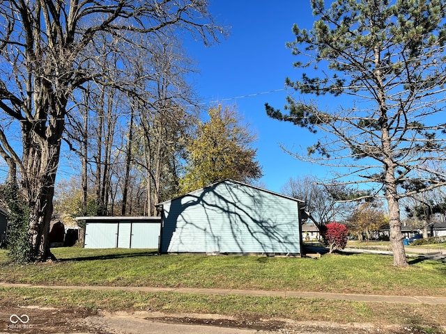 view of outdoor structure featuring a lawn