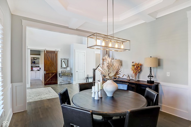 dining space with beam ceiling, a barn door, dark hardwood / wood-style floors, and crown molding