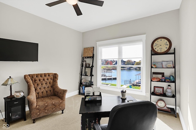 office with ceiling fan, a water view, and light colored carpet