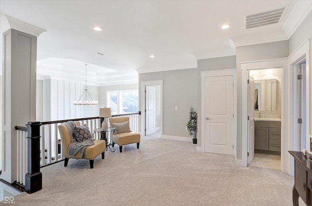 living area with light carpet, a chandelier, and ornamental molding