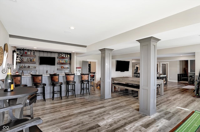 bar featuring gray cabinetry and hardwood / wood-style flooring