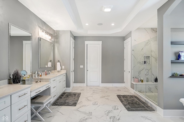 bathroom with vanity, a raised ceiling, and a shower with door