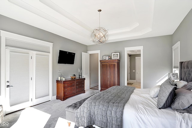 bedroom with light colored carpet and an inviting chandelier