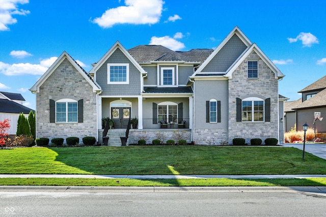 view of front of home with covered porch and a front lawn