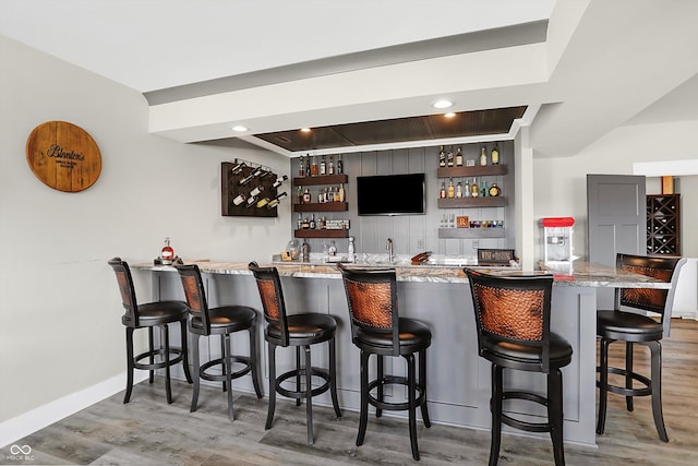 bar with hardwood / wood-style flooring