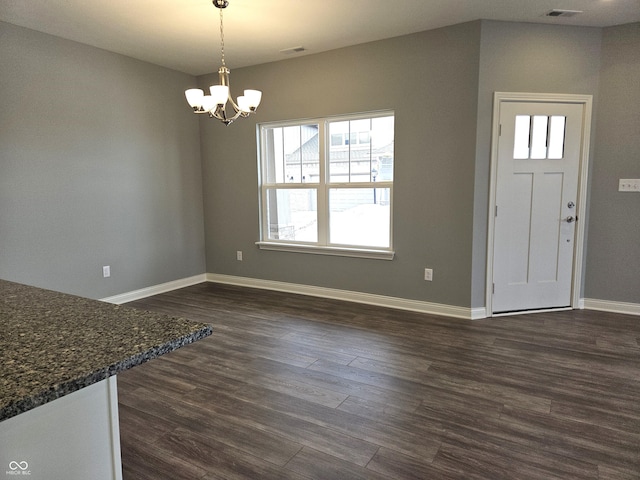 foyer featuring a chandelier and dark hardwood / wood-style floors