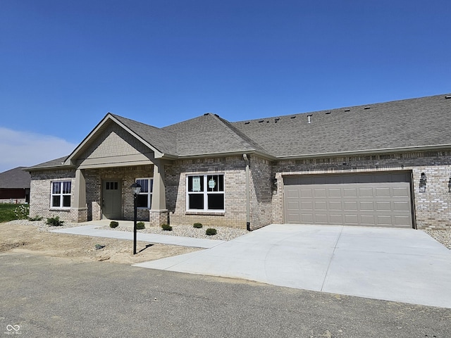 view of front of home featuring brick siding, driveway, and a shingled roof