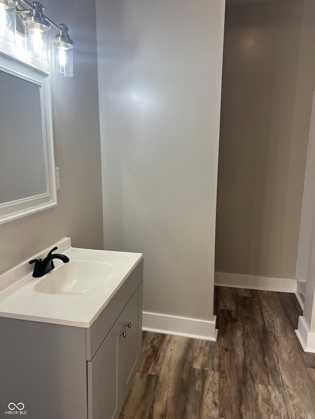 bathroom with hardwood / wood-style flooring and vanity