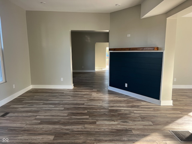 unfurnished living room featuring dark hardwood / wood-style floors