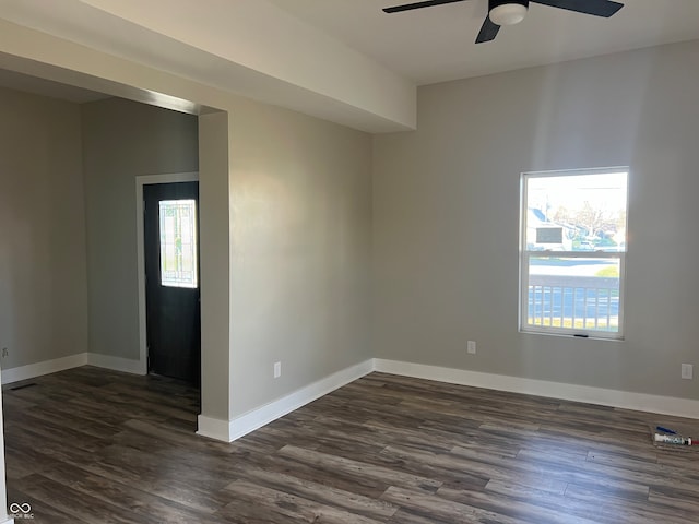 spare room with dark hardwood / wood-style flooring and ceiling fan