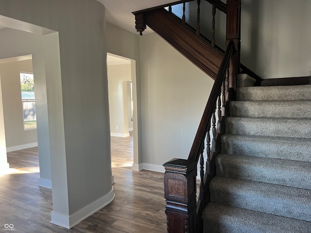 stairs featuring wood-type flooring