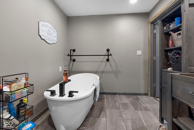 bathroom featuring hardwood / wood-style flooring and a bath