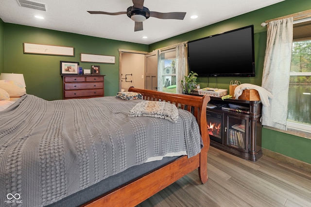 bedroom featuring ceiling fan and wood-type flooring