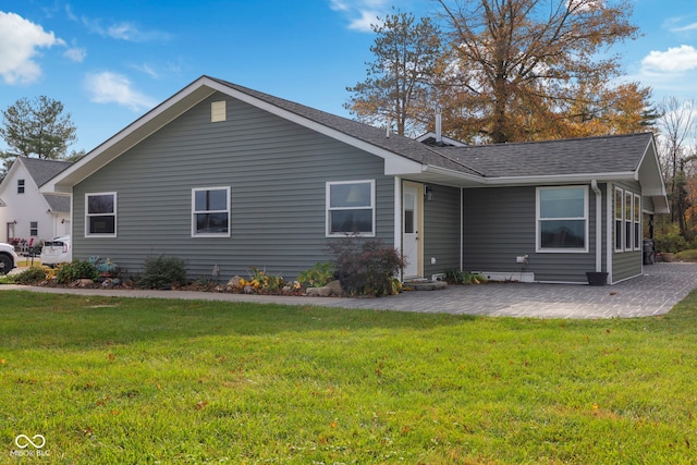 single story home with a front lawn and a patio area