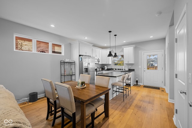 dining room with sink and light wood-type flooring