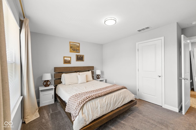 bedroom featuring dark colored carpet