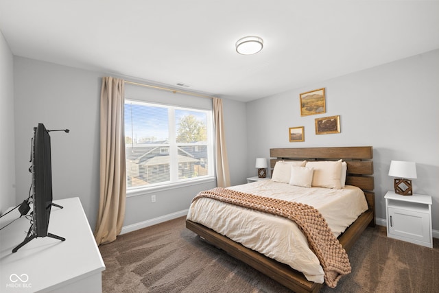 bedroom featuring dark carpet