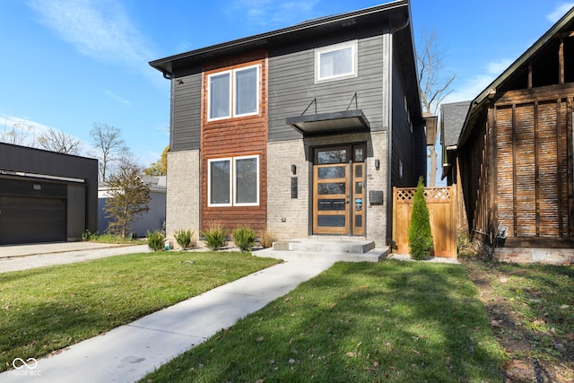 view of front of home featuring a front yard, a garage, and an outdoor structure