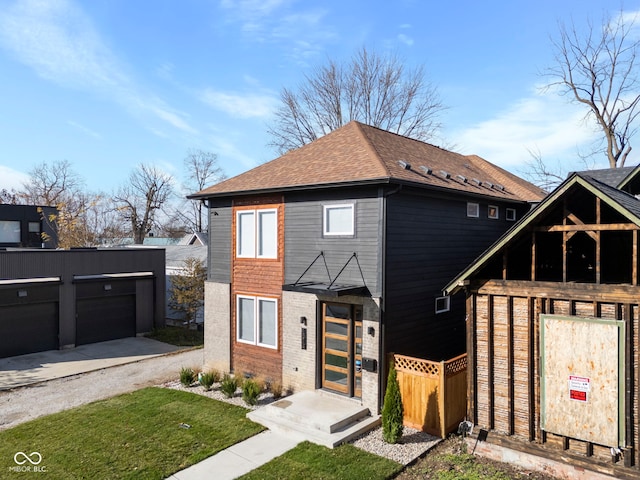 1514 E 12th St, Indianapolis, IN 46201 - view of front of property with an outbuilding, a shingled roof, and brick siding