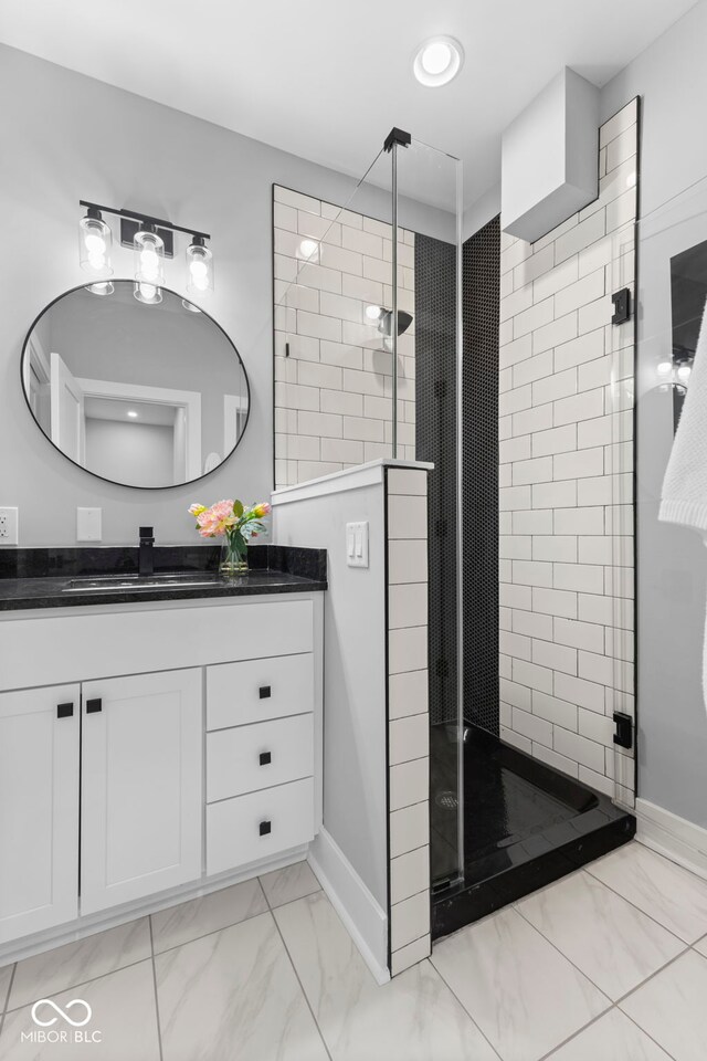 1514 E 12th St, Indianapolis, IN 46201 - bathroom featuring marble look tile flooring, vanity, a shower stall, and baseboards