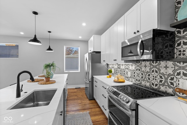1514 E 12th St, Indianapolis, IN 46201 - kitchen with stainless steel appliances, a sink, decorative backsplash, white cabinetry, and recessed lighting