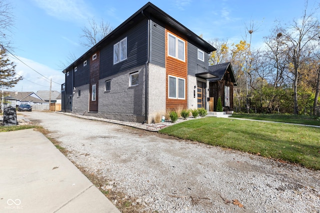 1514 E 12th St, Indianapolis, IN 46201 - view of side of property featuring brick siding and gravel driveway