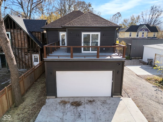 1514 E 12th St, Indianapolis, IN 46201 - rear view of property with an attached garage and concrete driveway