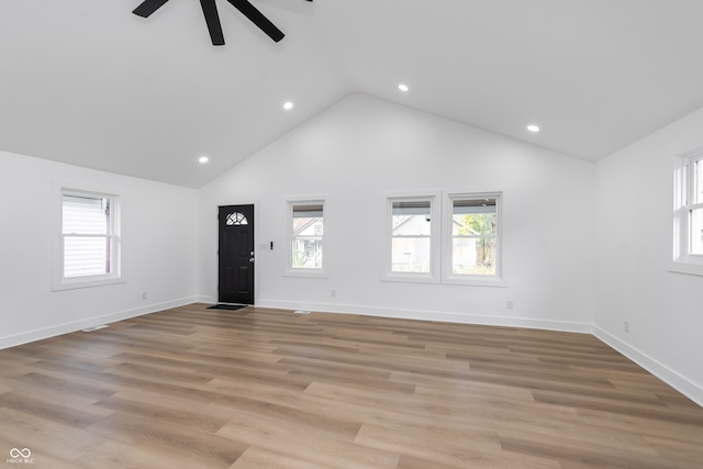 unfurnished living room featuring ceiling fan, light wood-type flooring, and high vaulted ceiling