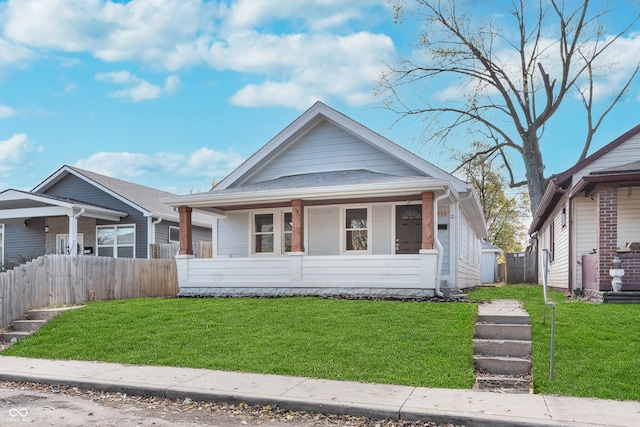 bungalow-style home featuring a porch and a front yard