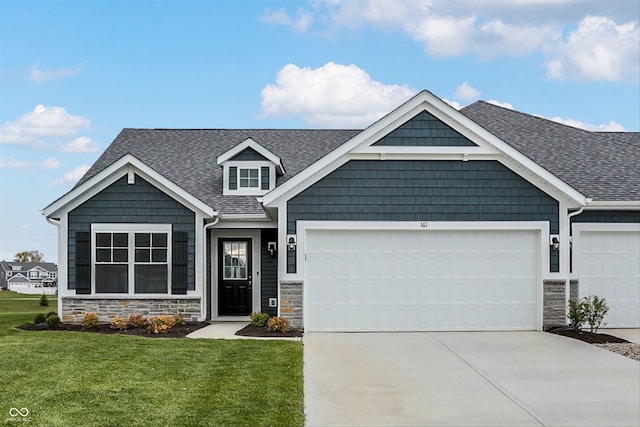 craftsman-style home with a garage and a front lawn