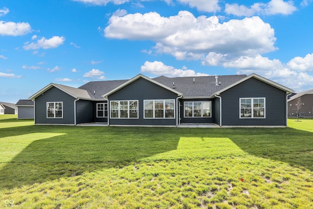 rear view of property featuring a lawn and a patio area