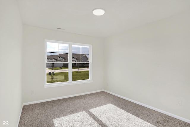 unfurnished room featuring carpet