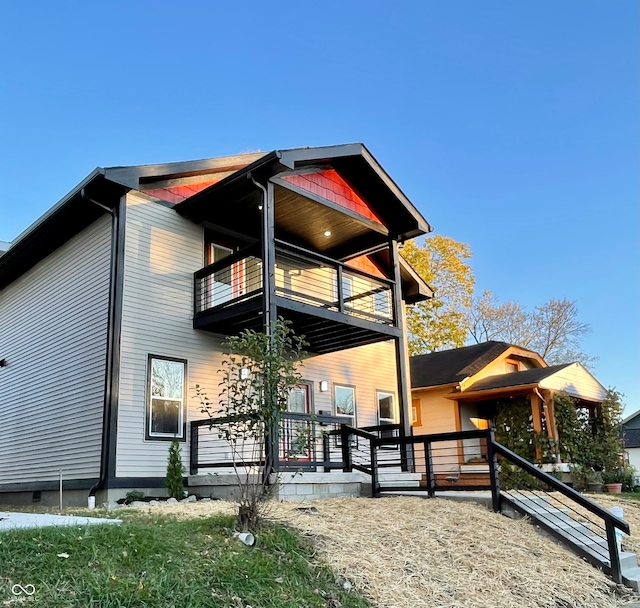 view of side of home featuring a balcony