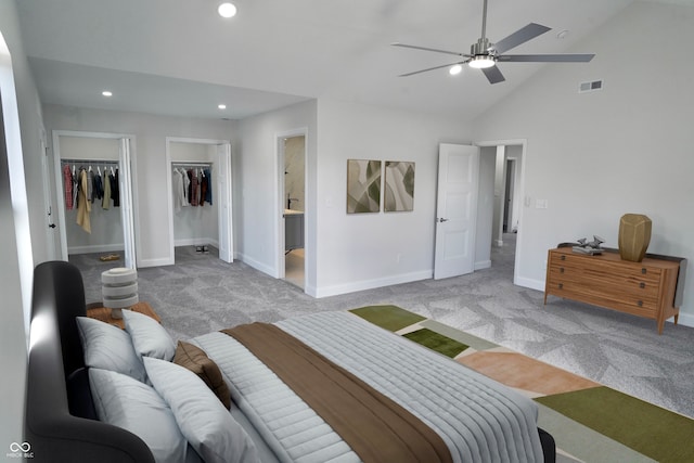 carpeted bedroom with ceiling fan, a spacious closet, high vaulted ceiling, and ensuite bath