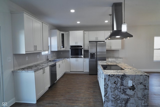 kitchen with appliances with stainless steel finishes, island range hood, dark wood-type flooring, white cabinets, and hanging light fixtures