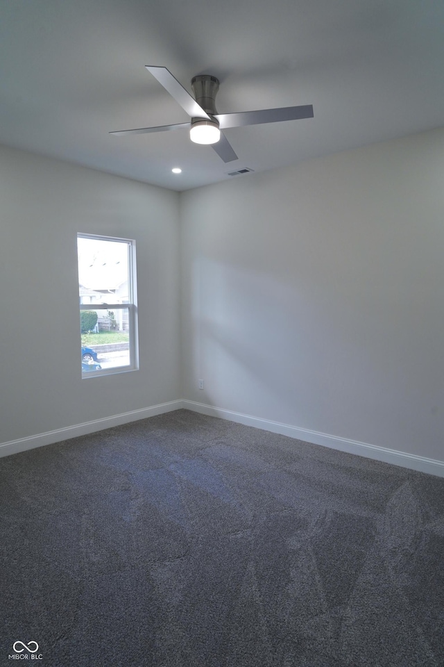 carpeted spare room with ceiling fan