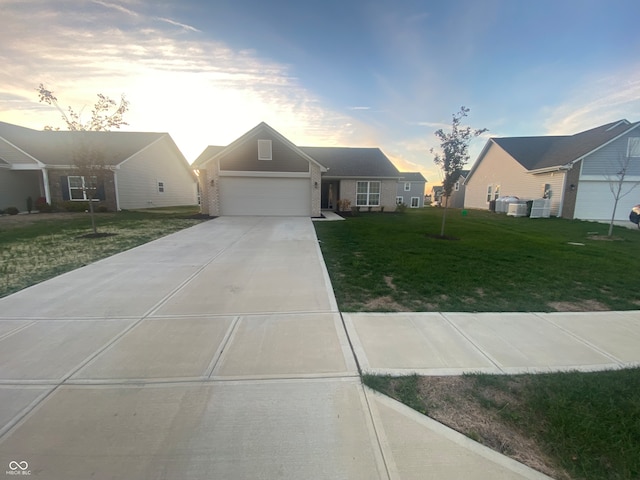 view of front of property with a garage and a lawn