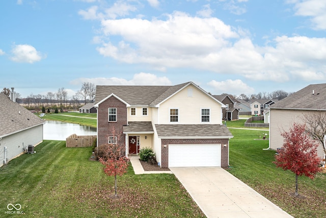 view of front property featuring a water view, a garage, central AC unit, and a front yard