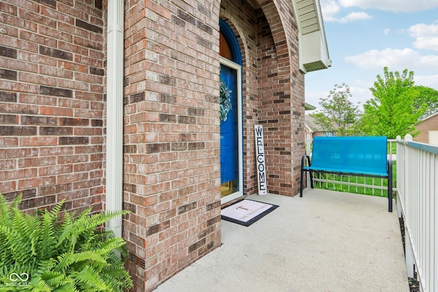 entrance to property featuring brick siding