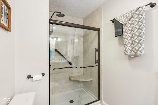bathroom with toilet and a shower stall