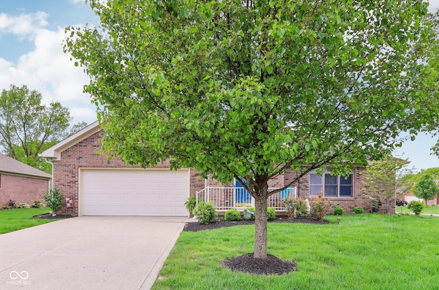 view of property hidden behind natural elements with concrete driveway, a garage, brick siding, and a front lawn