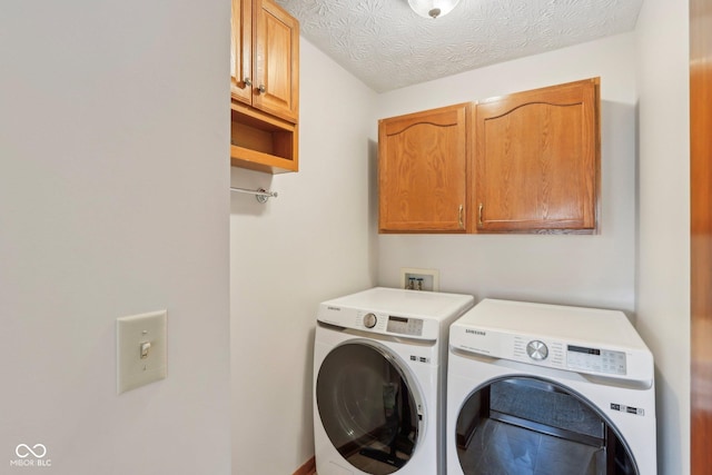 laundry room with cabinet space and washer and clothes dryer
