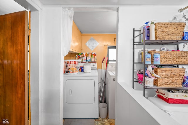 laundry area with washer and dryer and cabinets