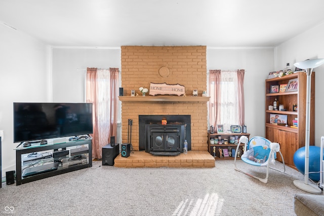 living room with a wood stove and carpet